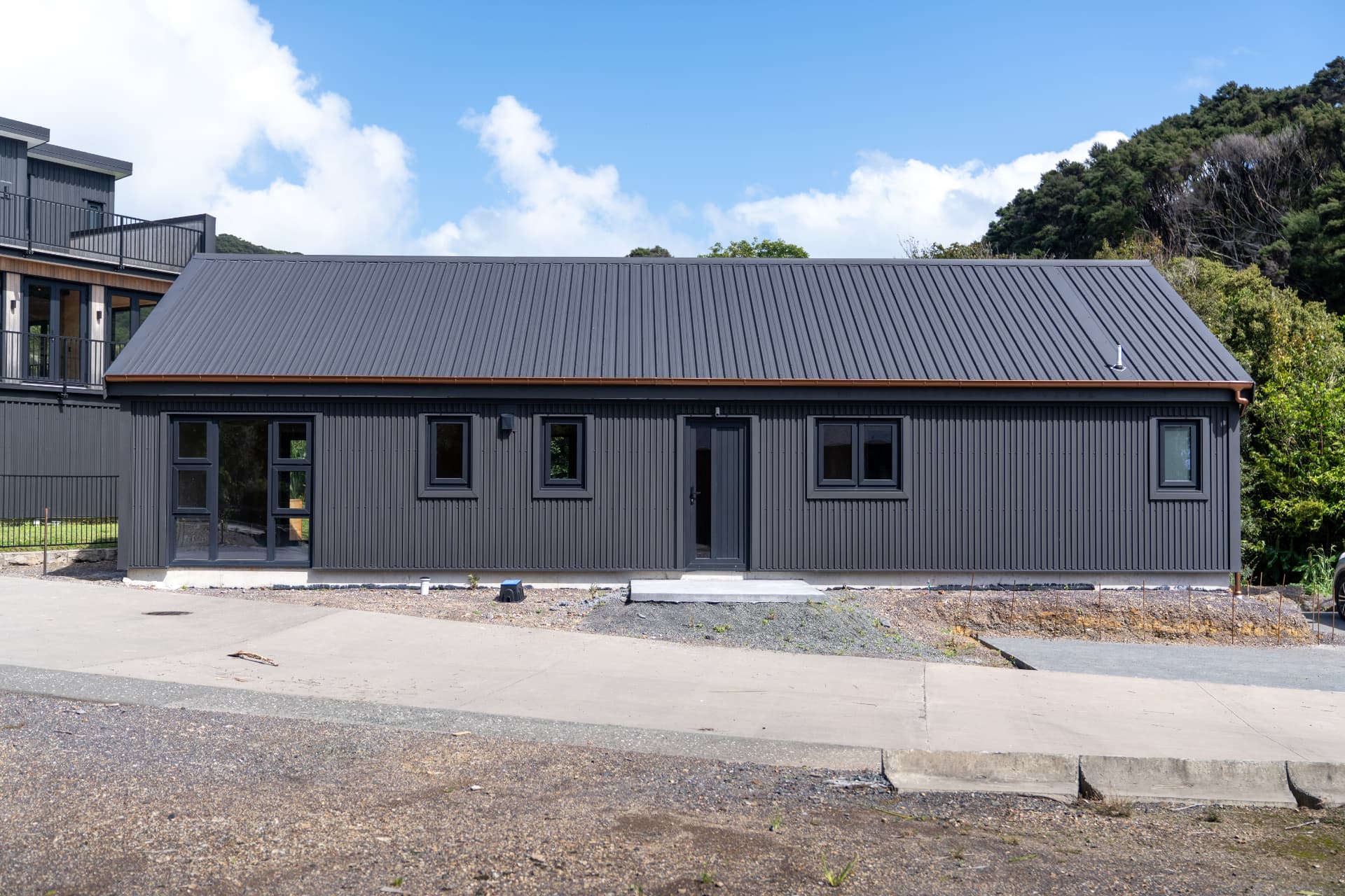 The Tūī — front elevation showing corrugated cladding and pitched roofline